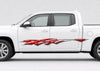 White four-door pickup truck with a glossy red and silver shard-style vinyl decal displayed along the driver side.-topaz-low resolution v2-2x
