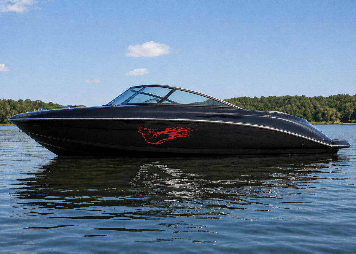 black speed boat sitting on water with red wolf flames vinyl cut graphics on hull