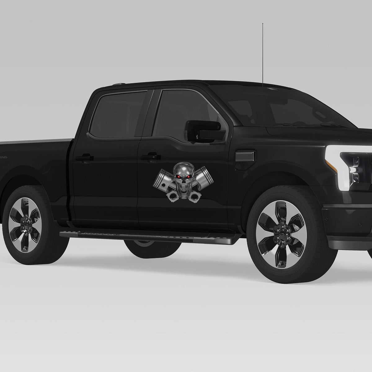 black truck with chrome skull and pistons vinyl graphics on passenger front door side