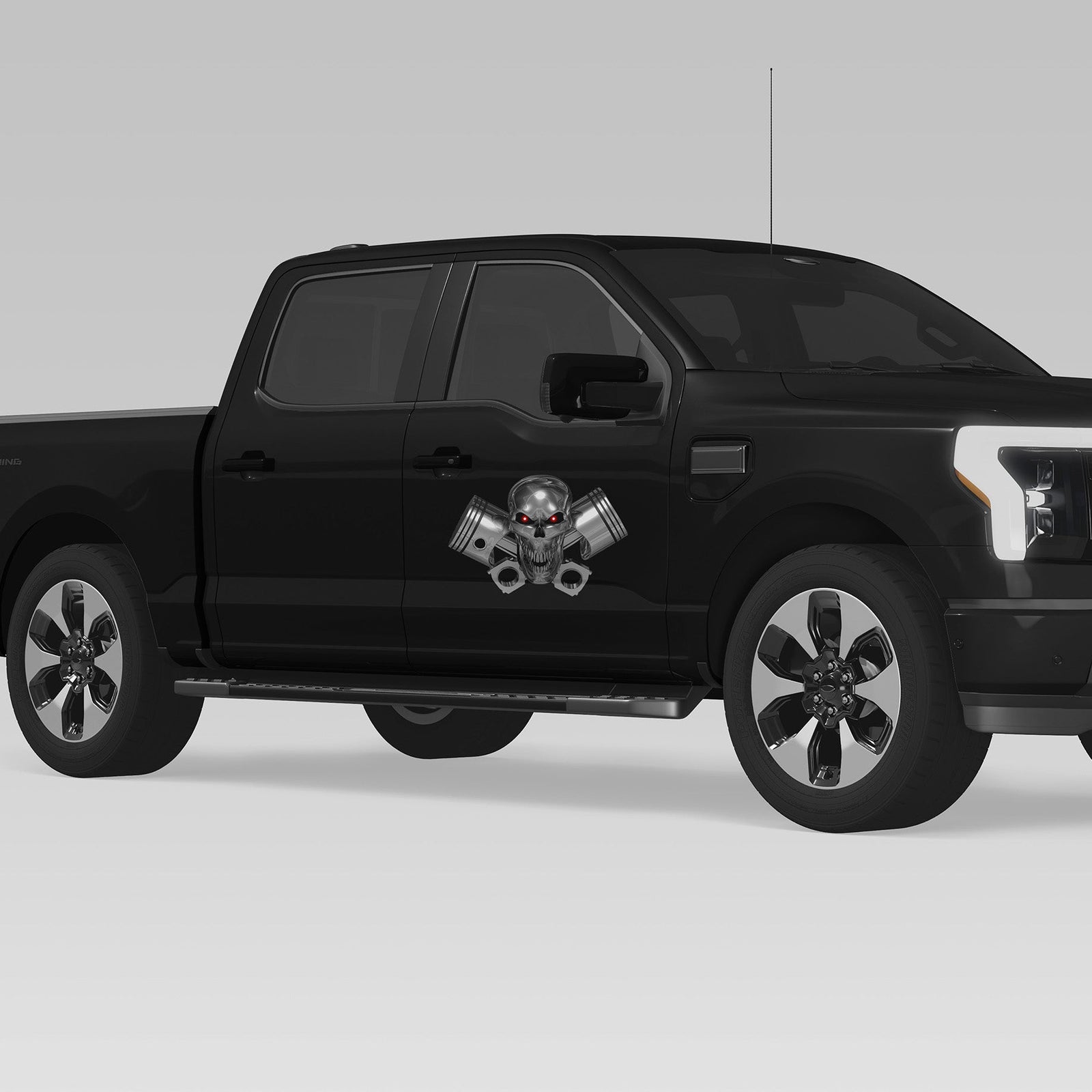 black truck with chrome skull and pistons vinyl graphics on passenger front door side
