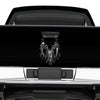 Black truck with a torn chrome ram head on tailgate 