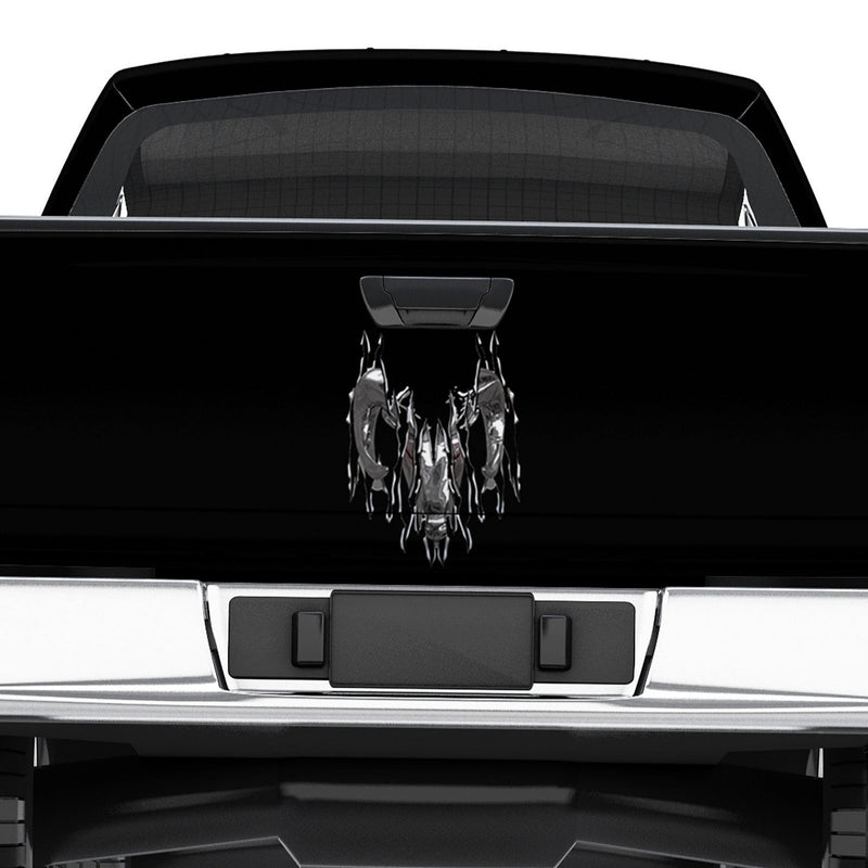 Black truck with a torn chrome ram head on tailgate 