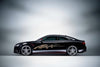 black sports car with flaming spear arc vinyl decal on driver side