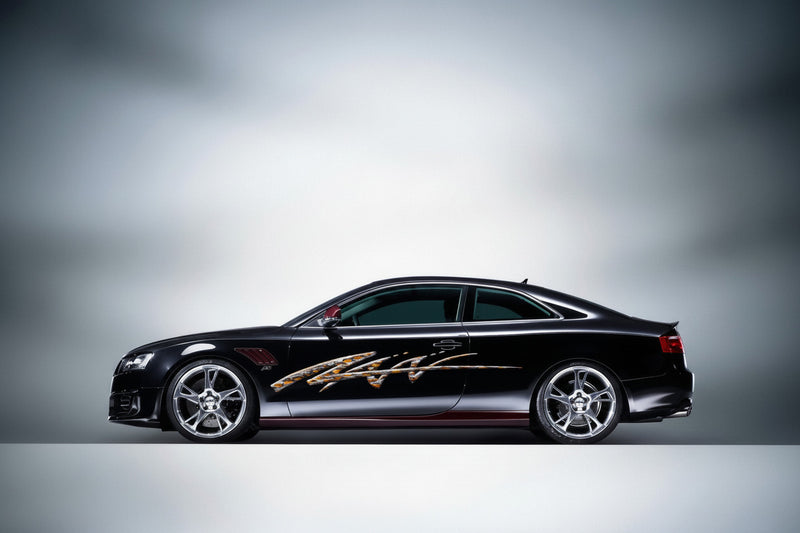 black sports car with flaming spear arc vinyl decal on driver side