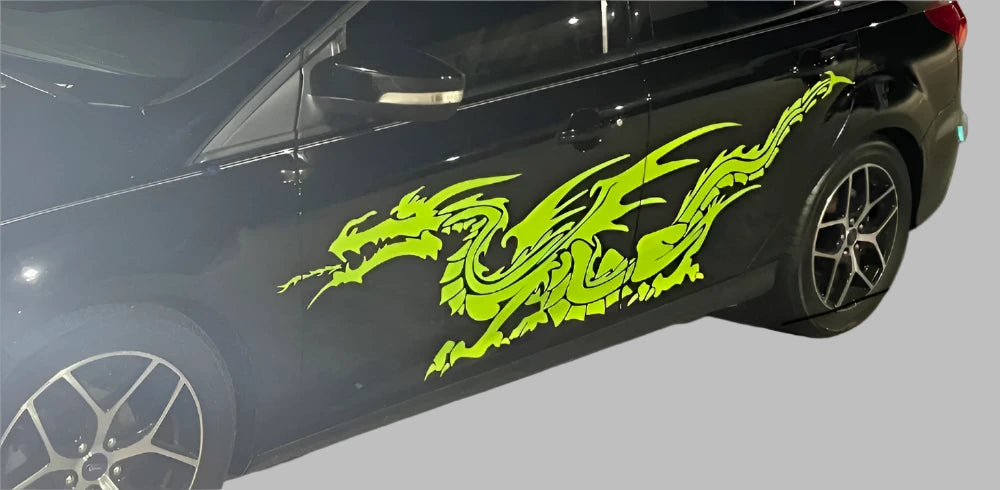 green dragon vinyl graphic on teh side of black car