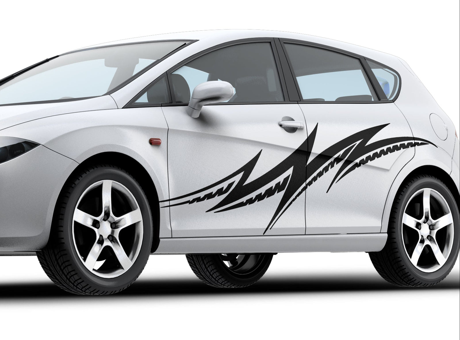 white hatchback car with black vinyl tribal noise decal on driver side