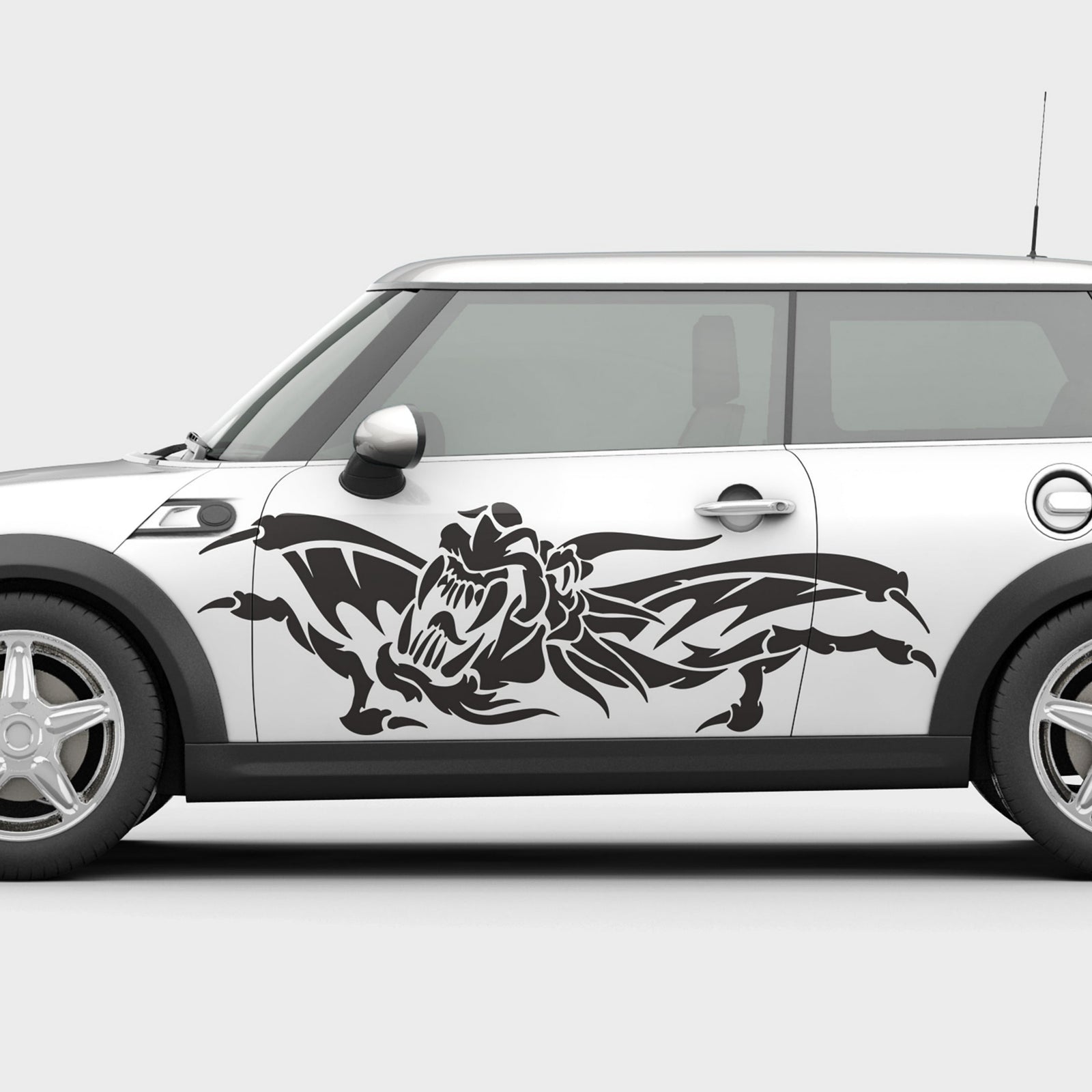 White car with black dragon decal on a white background
