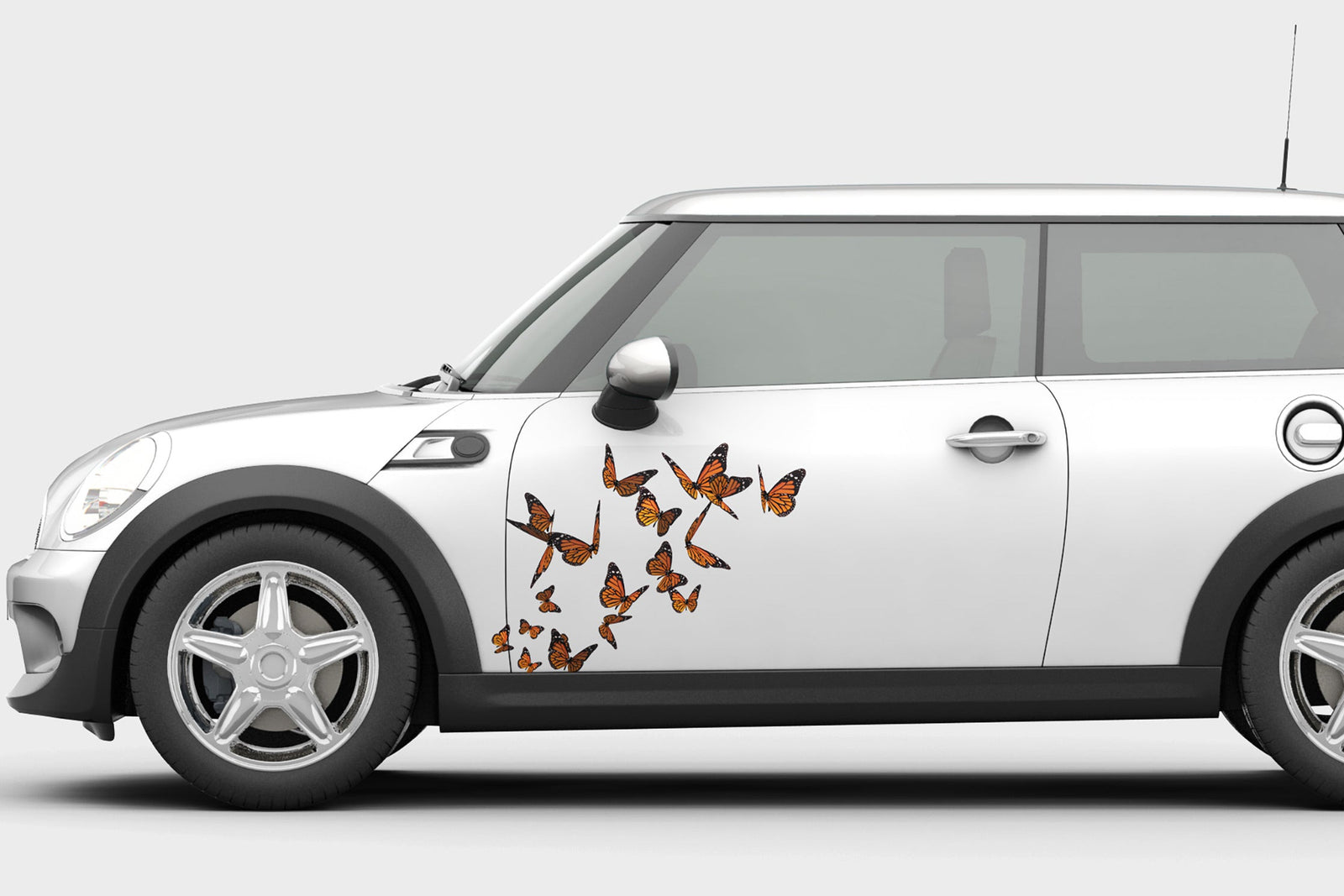 white mini cooper with butterflies decals on drivers door side view