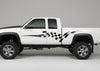 white raised truck with black checkers vinyl stripe graphics on driver side