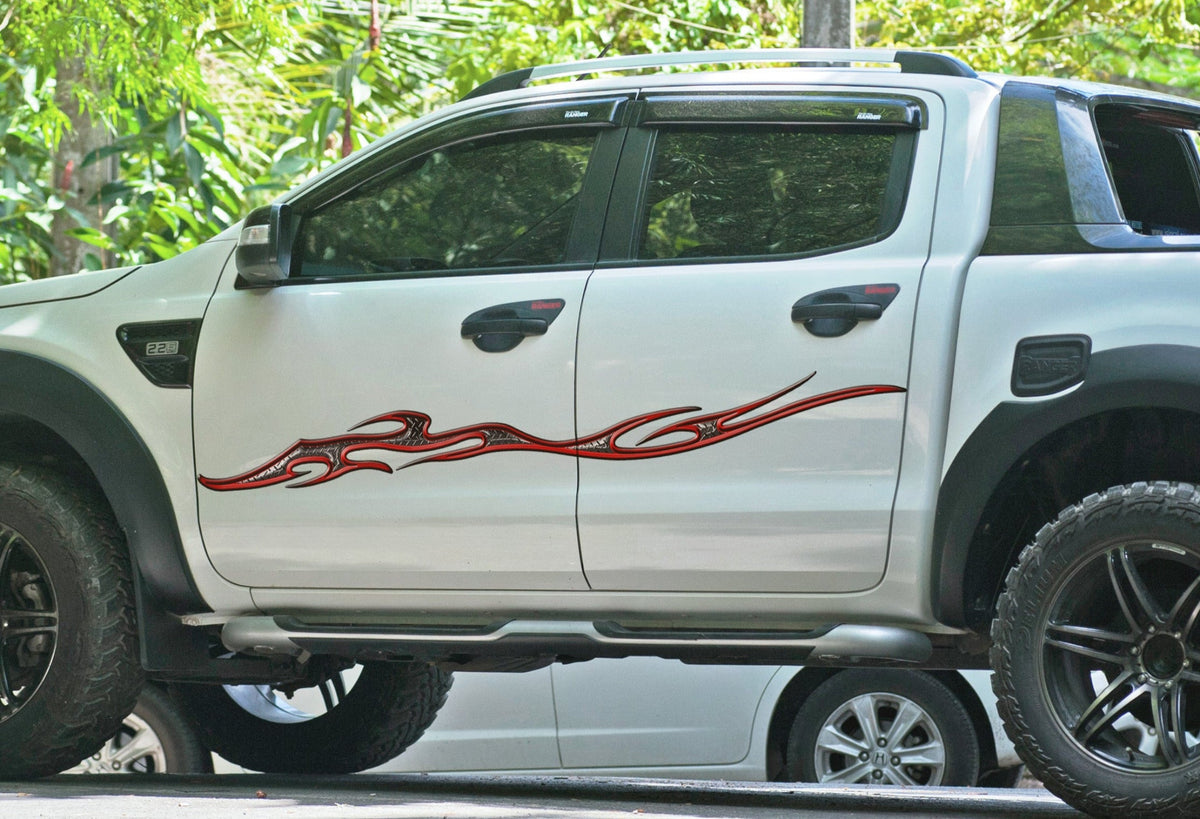 white truck with tempest diamond plate flame decal on driver side