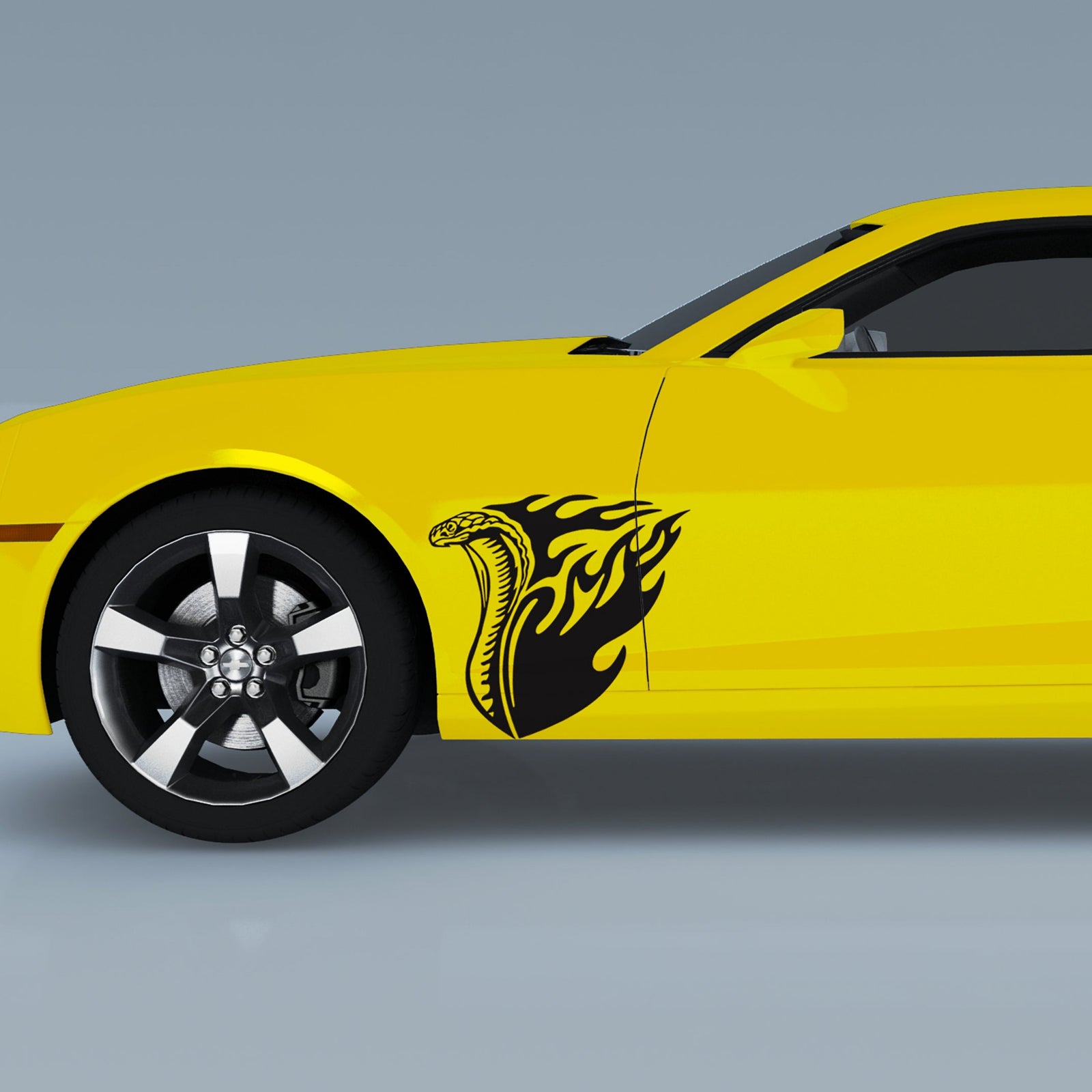Yellow muscle car with a black cobra flames design on its front side 