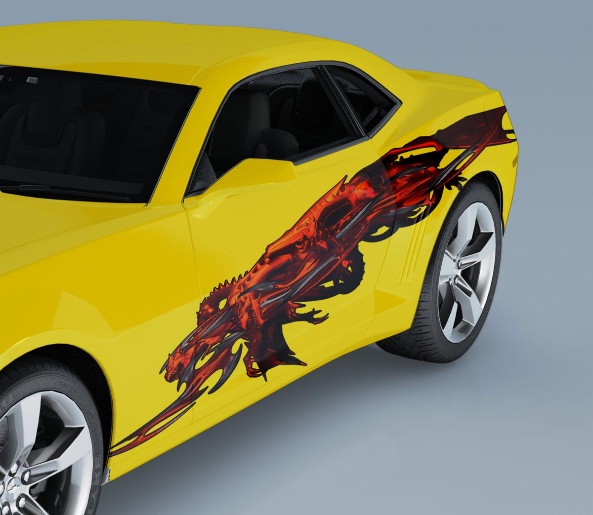yellow camaro with red tribal twin dragons on its driver side
