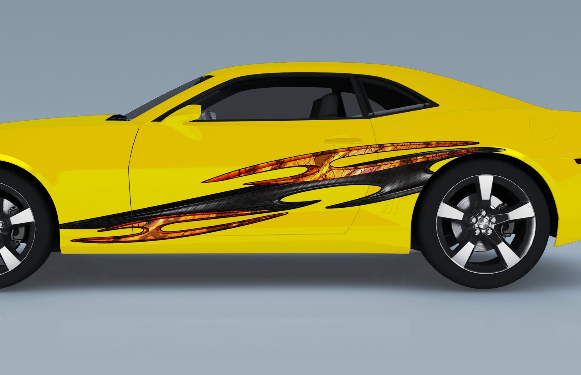 yellow camaro with tribal carbon fiber decal on driver side