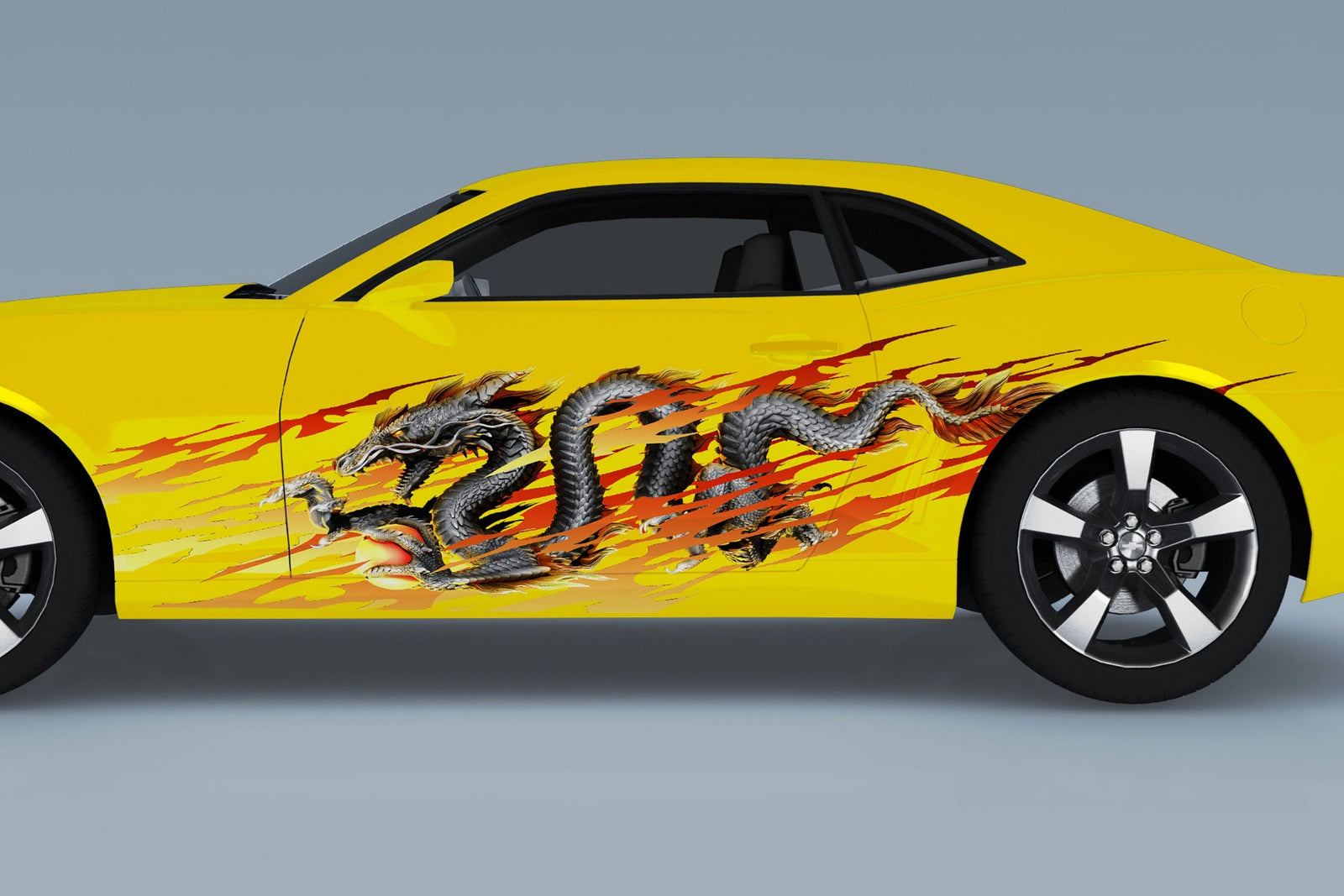 yellow camaro with dragon flame vinyl graphics on driver side