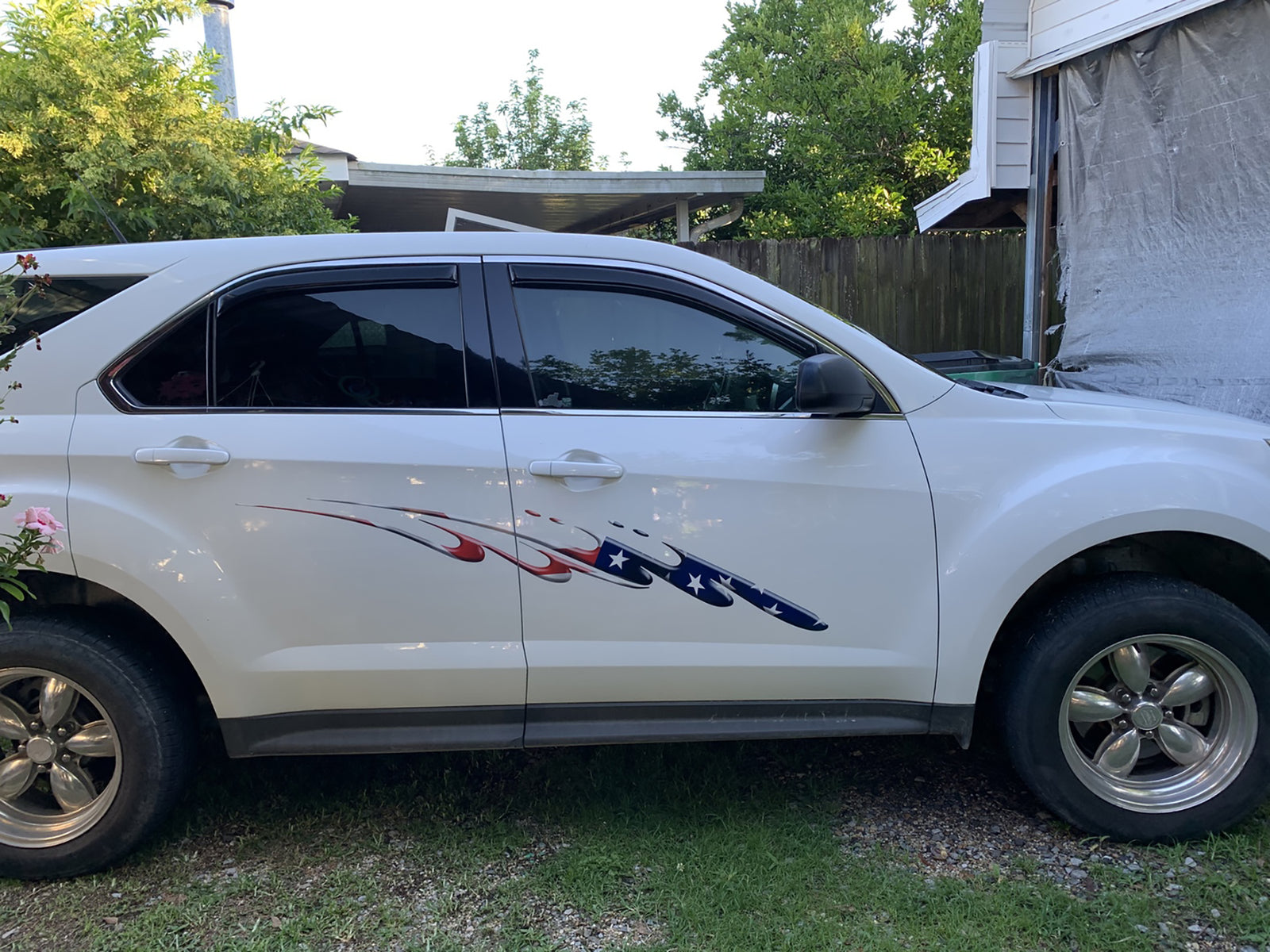 American flag decal on the side of white pickup truck