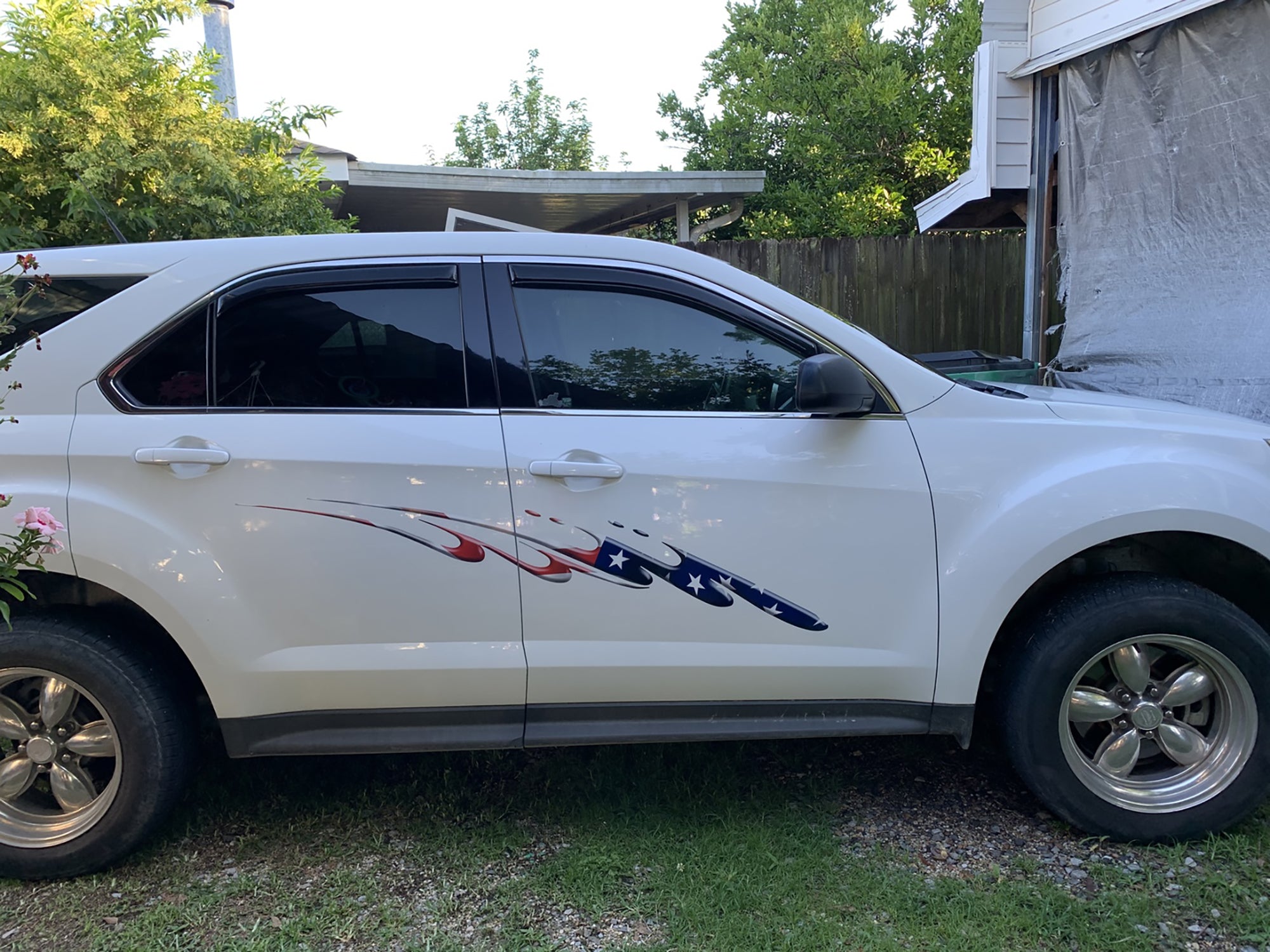 American flag decal on the side of white pickup truck