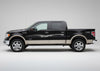 black pickup truck with silver vinyl  decal stripe on driver side