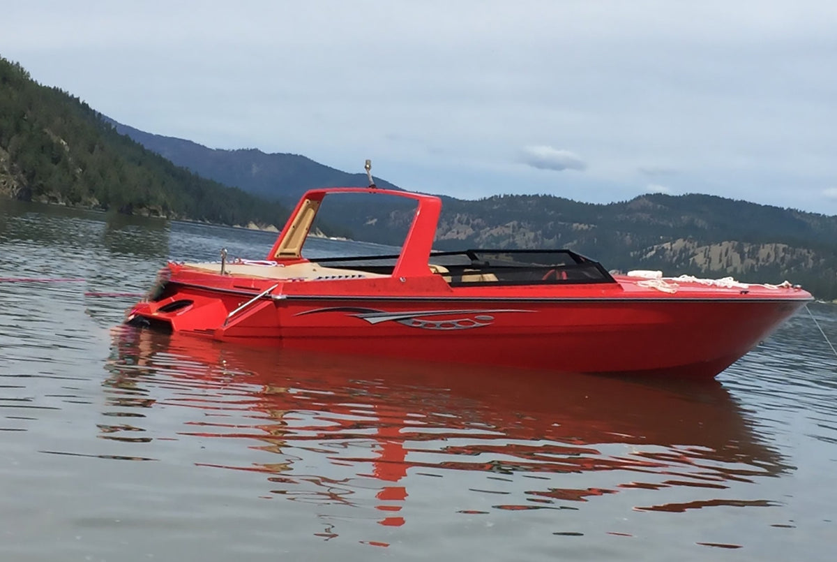 red customer speed boat with silver cosmos stripe graphics on the starboard side 