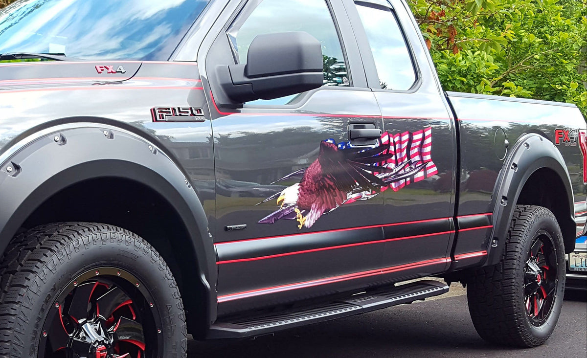gray 150 pickup truck with american flag bald eagle vinyl graphics on driver side, front side view.