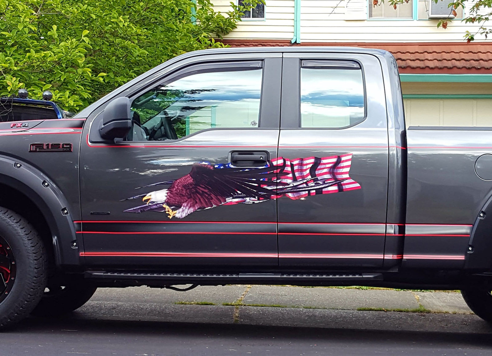 gray f150 ford truck with bald eagle american flag decal on cab side
