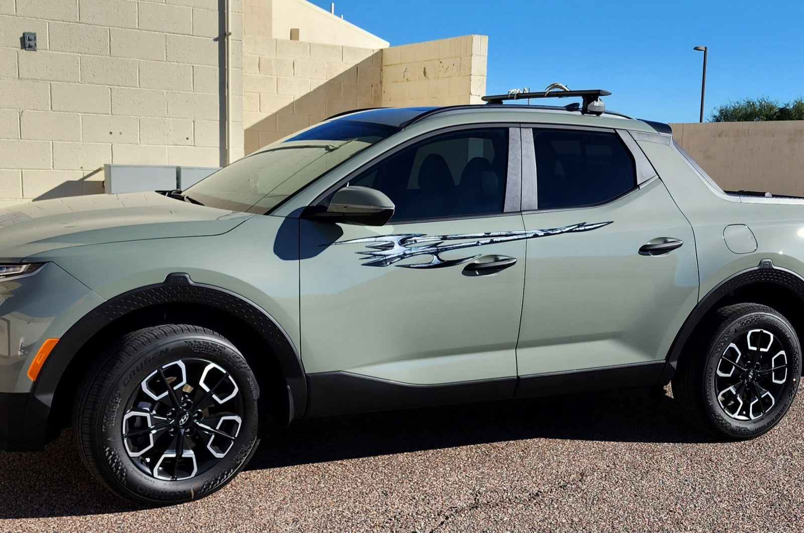 hyundai santa cruz truck with tribal edge graphics on it driver side, closeup view.