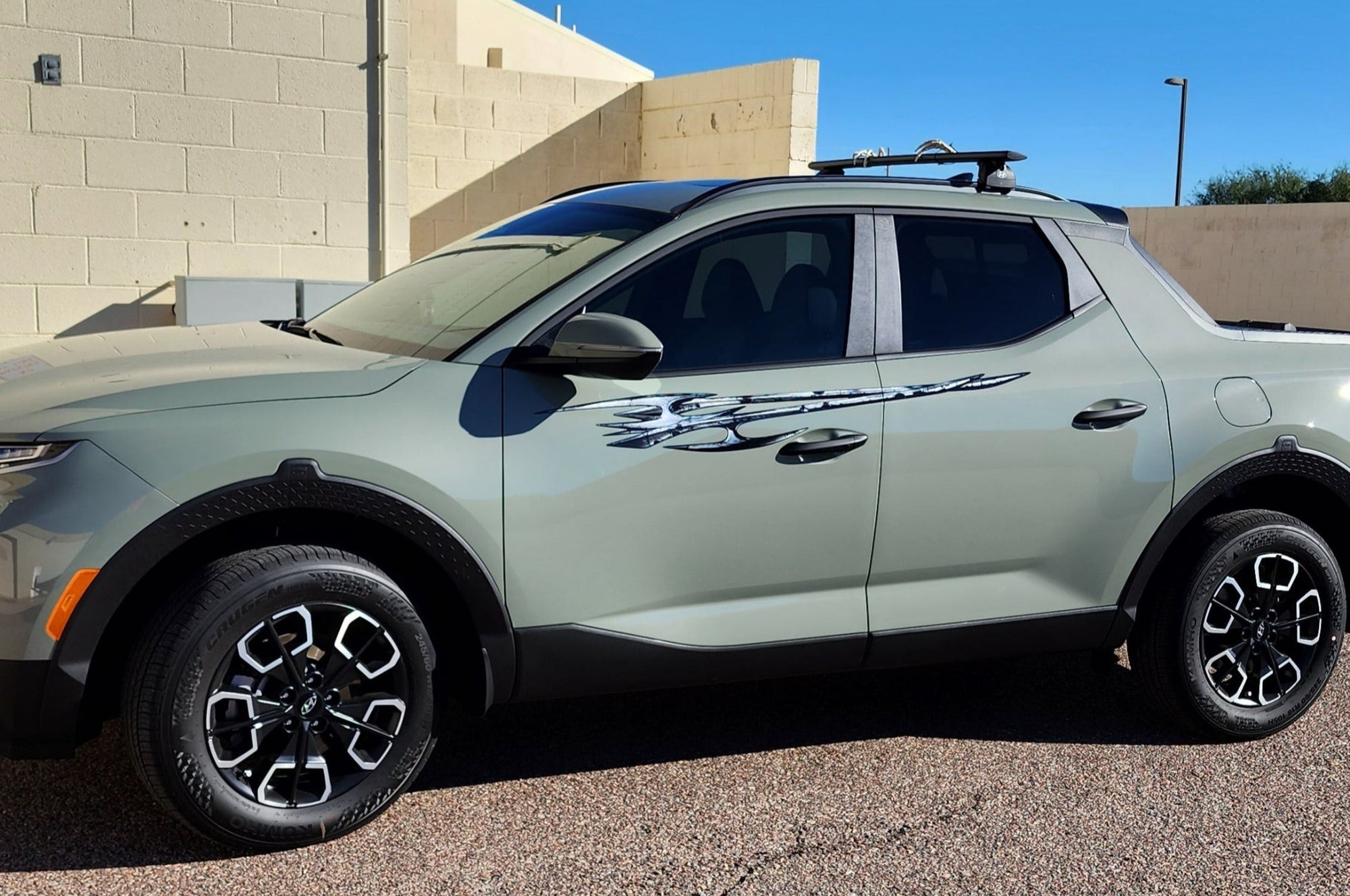 hyundai santa cruz truck with tribal edge graphics on it driver side, closeup view.