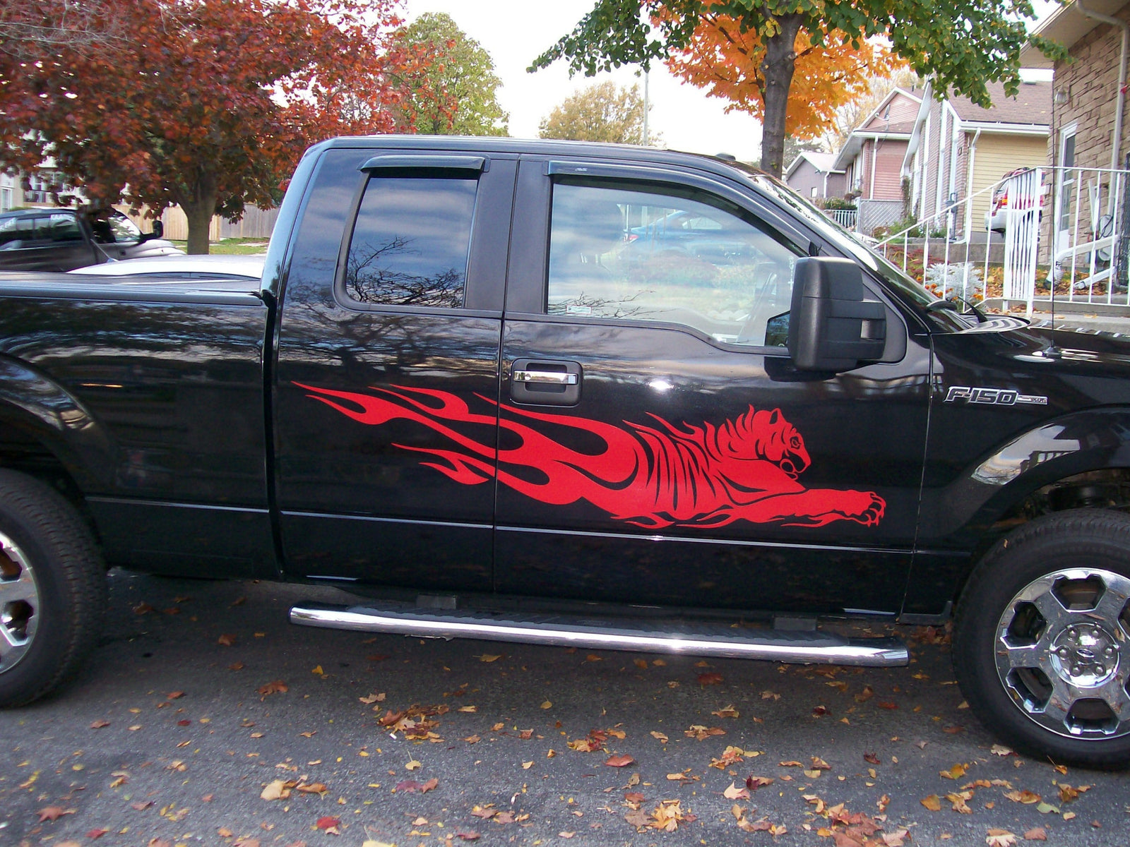 red tiger flames decal on the side of black truck