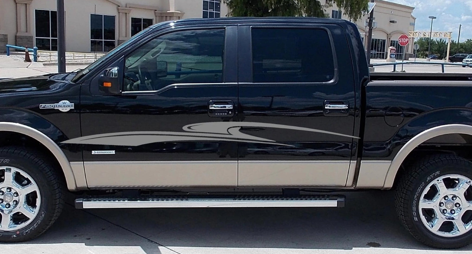 white pickup truck with black stripes on the side of it