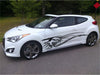 white hatchback car with black dragon skeleton vinyl graphics on driver side