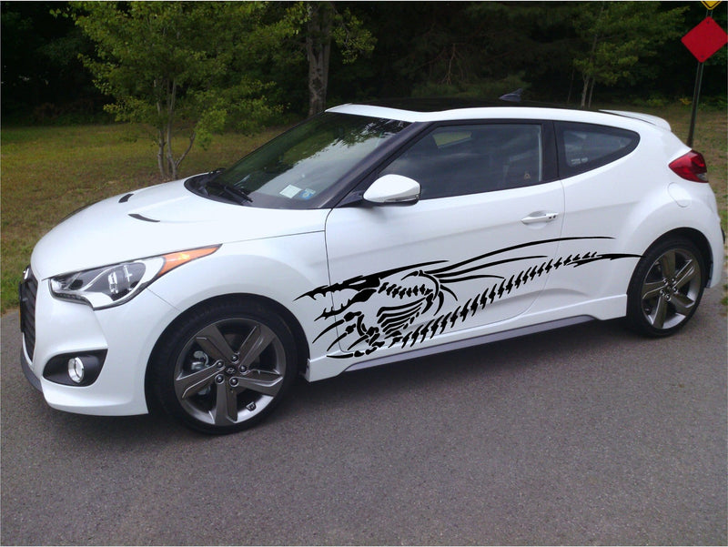 white hatchback car with black dragon skeleton vinyl graphics on driver side