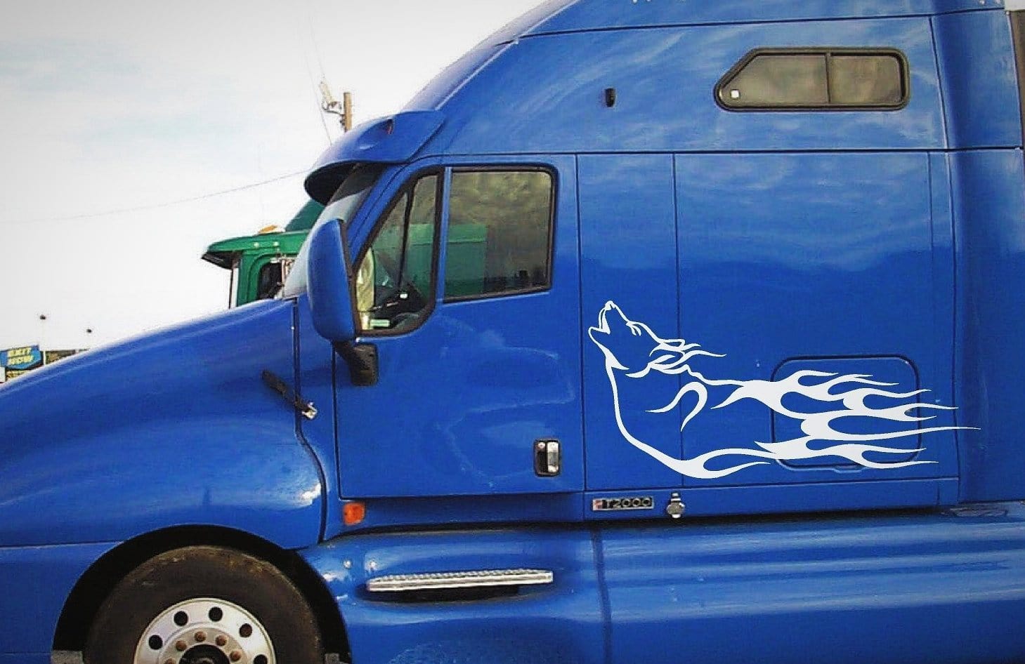 wolf howling Flames vinyl decal on blue semi
