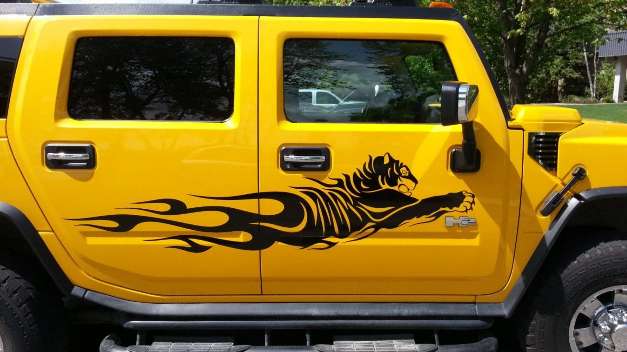 yellow H2 hummer with black tiger flames vinyl cut decal on passenger side