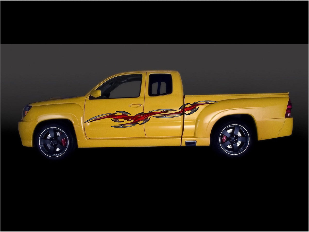 yellow pickup truck with tribal links decal on driver side